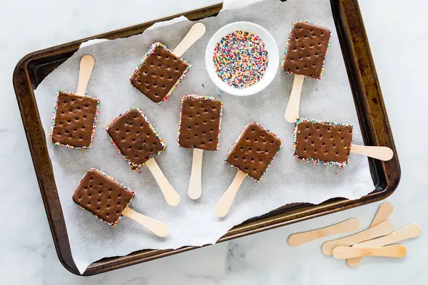 stock image Above view of Ice cream sandwich pops on a parchment lined baking sheet. 