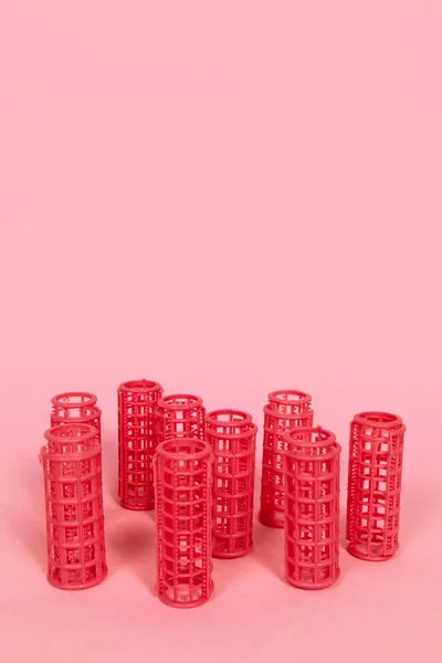 stock image Pink hair curlers on pink background