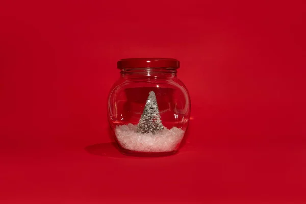 Christmas Tree Snow Glass Jar Red Lid Red Background Christmas — Stok fotoğraf