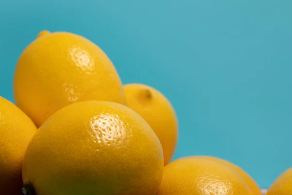 Yellow lemons on blue background