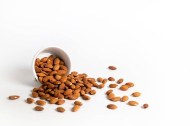 Almond spilled from a white ceramic bowl