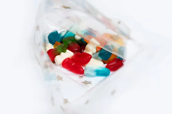 Candy in a cellophane bag with a stars pattern on a white background
