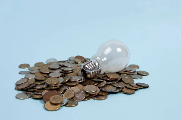 Light bulb on a pile of coins