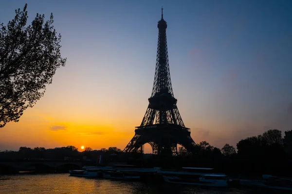 Eiffel Tower, French: Tour Eiffel, silhouette at sunrise time on sunny day. View from Seine River. Paris, France