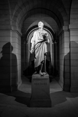 PARIS, FRANCE - APRIL 16, 2023: Statue and tomb of Voltaire, 1694 - 1778, famous French writer and philosopher. Pantheon in Paris, France. Black and white photography. clipart