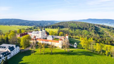 Hora Matky Bozi Monastery in Dolni Hedec, Czechia. The monastery is nestled on a hilltop overlooking the town and countryside. The photo showcases the unique architecture and the scenic landscape. clipart