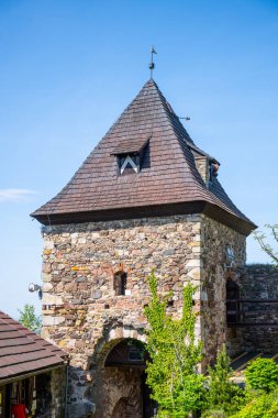 A view of the gate tower at Potstejn Castle Ruins in Czechia, with its stone walls, wooden roof, and a small window. clipart