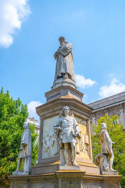 Stock image A striking sculptural group honors Leonardo da Vinci in Milans Piazza della Scala, featuring detailed statues of the great artist surrounded by notable figures from his era.