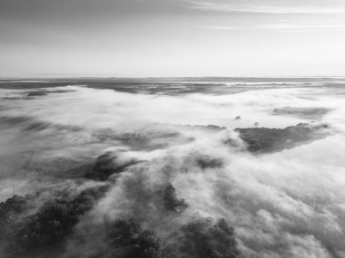 Fog envelops Rozmberk Pond in Trebon during a serene morning. The tranquil waters reflect the mist, creating a peaceful atmosphere as nature awakens to a new day. clipart