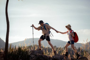 Gezginler ya da gezginler sırt çantası taşıyan gezginler, yürüyüş direkleri uzak mesafeye bakar ve muhtemelen yürüyüş ve yol keşfi ve tatil eko-turizmi kavramına rehberlik ederler..