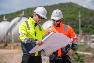 Çevre mühendisi veya işçiler, sistemlerin etkin çevre düzenlemelerini sağlamak için büyük bir endüstriyel atık su veya kirlilik izleme ve bakımı boyunca atık suyu inceleyen işçiler.