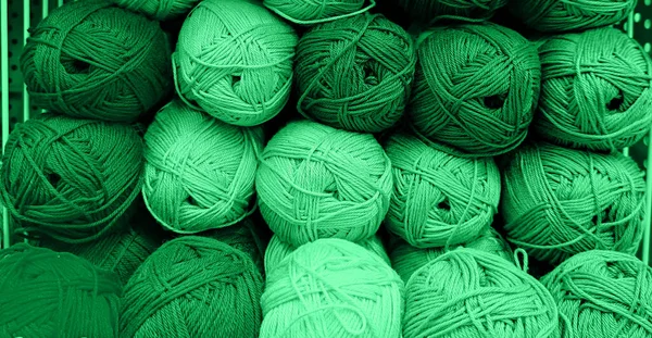 Colorful of Yarn Balls Wool in a Fabric Shop. Background from colored acrylic yarn. Skeins of thread close-up. Materials for needlework, for knitting and crocheting.
