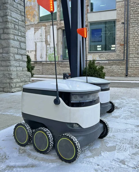 Autonomous delivery robot on Tallinn, Estonia. Estonian company developing autonomous delivery vehicles. Delivery robot waiting for order at cafe or restaurant. Technology, unmanned courier robot.