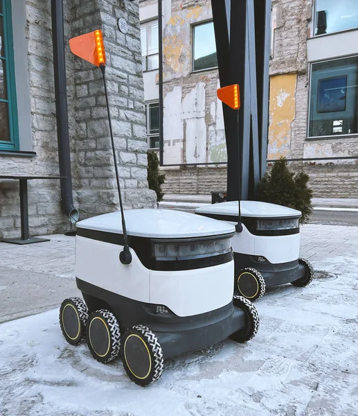 Autonomous delivery robot on Tallinn, Estonia. Estonian company developing autonomous delivery vehicles. Delivery robot waiting for order at cafe or restaurant. Technology, unmanned courier robot. 