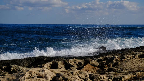 stock image Blue sea wave and white foam and splash. Stone beach on island of Malta, no sandy beach. Summer holiday border frame concept. Tropical island vacation backdrop. Tourist travel banner design template.