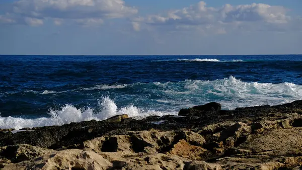 Stock image Blue sea wave and white foam and splash. Stone beach on island of Malta, no sandy beach. Summer holiday border frame concept. Tropical island vacation backdrop. Tourist travel banner design template.