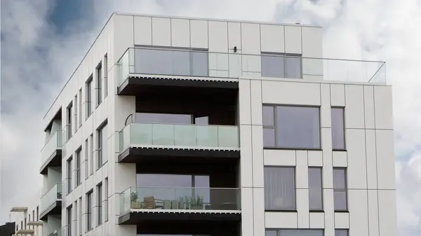 Stock image Exterior of modern house in new area of the city. Architectural detail of close-up on windows, glass balconies. Real estate, residential apartment and office building architecture.