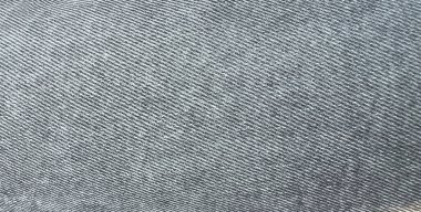 Siyah-beyaz, gri kot pantolon, herhangi bir arka plan için tekstil. Soluk siyah kot pantolon. Denim kumaşı. Branda kot kumaşı. 