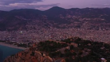 Akşam Alacakaranlığı 'ndaki Alanya Şehri ve Kalesi. Hava görüntüsü. Türk Rivierası. Hindi. Yörüngede