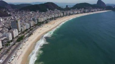 Rio de Janeiro City on Sunny Day. Copacabana Beach and Atlantic Ocean. Aerial View. Brazil. Drone Flies Forward, Tilt Up. Reveal Shot
