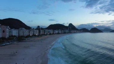 Rio de Janeiro City at Morning Twilight. Copacabana Beach and Atlantic Ocean. Blue Hour. Aerial View. Brazil. Drone Flies Backwards and Upwards