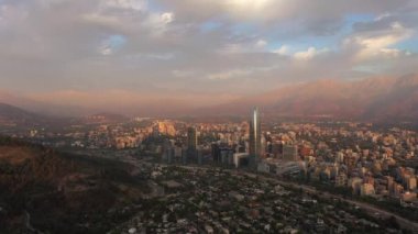 Santiago City at Sunset and Andes Mountains. Aerial View. Chile. Drone Flies Sideways