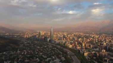 Santiago City at Sunset and Andes Mountains. Aerial View. Chile. Drone Flies Forward