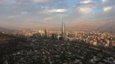 Santiago City at Sunset and Andes Mountains. Aerial View. Chile. Drone Flies Backwards and Upwards