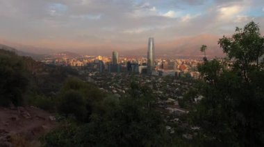 Santiago City at Sunset and Andes Mountains. Aerial View. Chile. Drone Flies Forward. Reveal Shot