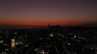 Sparkling Santiago Skyline at Night. Aerial View. Las Condes Commune. Chile. Drone Flies Forward