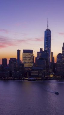 New York, Aşağı Manhattan 'daki Urban Skyline' ı sabahın mavi saatinde aydınlatmış. Hava Hızı Hızı, Zaman Hızı. Amerika Birleşik Devletleri. İnsansız hava aracı yandan uçuyor. Dikey Video
