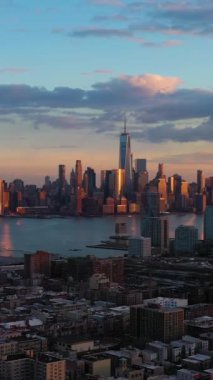 Aşağı Manhattan, Jersey City ve Hudson River 'ın şehir manzarası. New York, Sunset 'te. Hava görüntüsü. Amerika Birleşik Devletleri. Drone İleri Uçuyor. Dikey Video