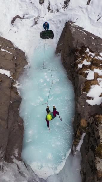 Ice Climbing Frozen Waterfall Mountaineer Woman Leading Ice Aerial Top — Stock Video