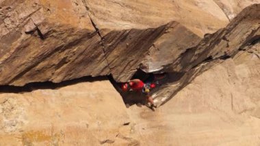 Tırmanan Adam Kaya tırmanışı. Crack Trad Tırmanışı. Tamgaly Tas, Kazakistan 'daki kayalıklar. Hava görüntüsü. Yörüngede. Dikey Video