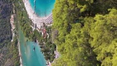 Mavi Göl, güneşli bir günde. Hava görüntüsü. Türk Rivierası. Oludeniz, Türkiye. İHA ileri uçar, aşağı eğilir. Şutu göster. Dikey Video