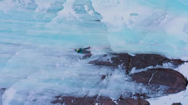 Ice Climbing Frozen Waterfall Aerial View Mountaineer Man Leading Ice — Stock Video