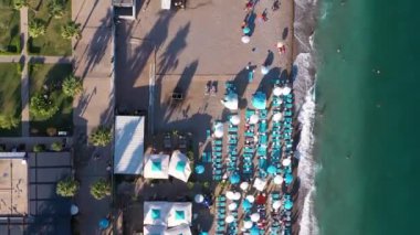 Antalya 'daki Konyaalti Plajı. Hindi. Sea ve Embankment. Havadan Yukarıdan Aşağı Görünümü. İnsansız hava aracı yandan uçuyor. Dikey Video