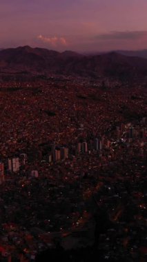 Akşam Alacakaranlığı 'nda La Paz Cityscape ve Illimani Dağı. Hava görüntüsü. Bolivya 'da. Mavi Saat. Drone İleri Uçuyor, Eğil. Geniş açı. Şutu göster. Dikey Video