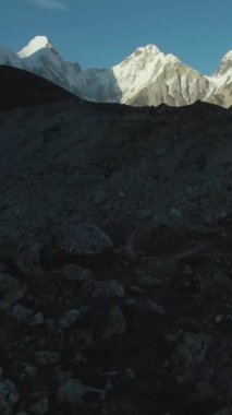 Güneşli bir günde Pumori, Lingtren, Khumbutse ve Nuptse Dağları. Himalaya, Nepal. Hava görüntüsü. Drone İleri Uçuyor, Eğil. Şutu göster. Dikey Video