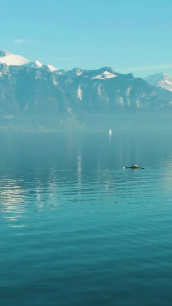 Two Men Kayaking Clear Day Turquoise Lake Geneva Snow Capped — Stock Video