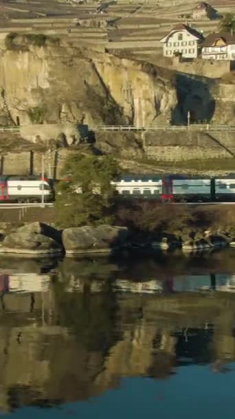 Pociąg Pasażerski Dwupokładowy Jedzie Wzdłuż Jeziora Genewskiego Refleksja Wodzie Tarasowane — Wideo stockowe
