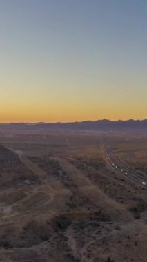 Sunset 'te çölde trafik vardı. Arizona, ABD. Hava görüntüsü. Hava Hızı Hızı, Zaman Hızı. Drone İleri Uçuyor. Dikey Video