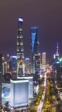 Gece Şangay 'da. Lujiazui Bölgesi ve Century Bulvarı. Çin. Hava Hızı Hızı, Zaman Hızı. Drone Yana ve Yukarı Uçuyor. Dikey Video