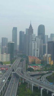 Guangzhou Şehri ve Kompleks Yolu Üstgeçidi. Guangdong, Çin. Bulutlu bir gün. Hava görüntüsü. Drone İleri Uçuyor. Dikey Video