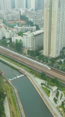 Shenzhen Şehri ve Passing Train. Çin. Hava görüntüsü. Dikey Video