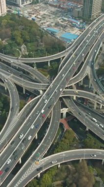 Sunny Day 'de Karmaşık Yol Kavşağı. Şangay, Çin. Hava görüntüsü. Drone yörüngede. Dikey Video