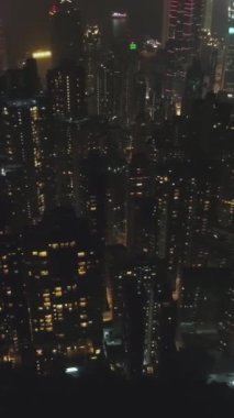 Geceleyin Hong Kong Konutları. Havadan Yukarıdan Aşağı Görünümü. İnsansız hava aracı Yanlamasına uçuyor. Atış ayarlanıyor. Dikey Video