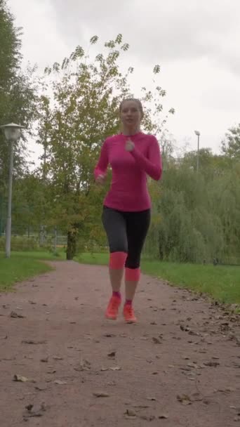 Young Caucasian Woman Jogging Green Urban Park Fallen Leaves Path — Stock Video