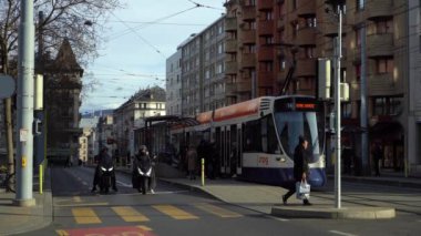 GENEVA, SWitzERLAND - 20 Şubat 2024: Tramvaylar ve Servette Caddesi 'ndeki İnsanlar