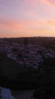 Azenhas, Sabah Alacakaranlığı, Atlantik Okyanusu 'nun Kayalıkları ve Dalgaları' nda Portekiz 'deki Mar Village' ı yapıyor. Hava görüntüsü. Drone yukarı ve geri hareket ediyor. Dikey Video